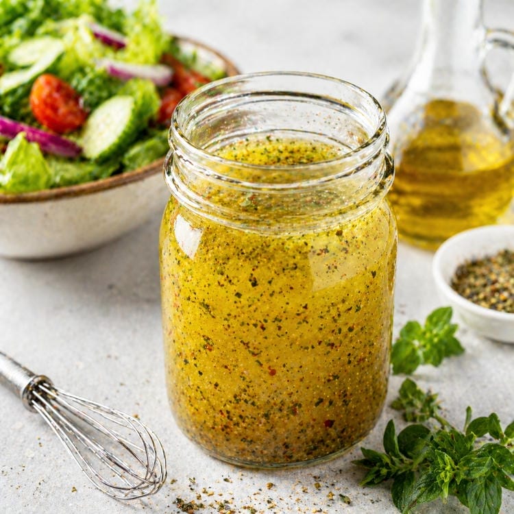 Homemade vinaigrette dressing with olive oil and herbs.